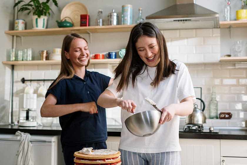 two happy women cooking in the kitchen